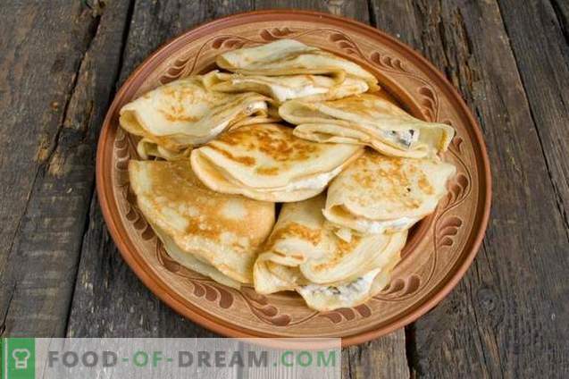 French crepes. Thin pancakes with prunes and curd